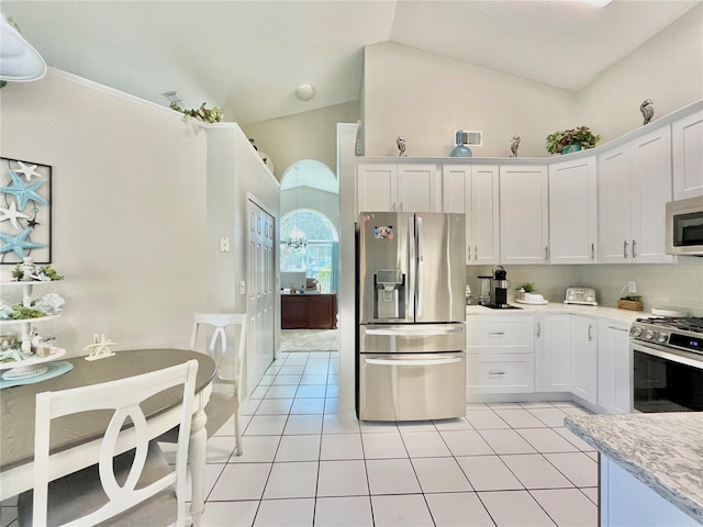 kitchen featuring appliances with stainless steel finishes, high vaulted ceiling, white cabinets, and light tile patterned floors