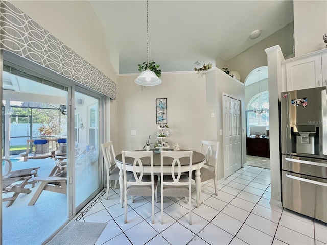 tiled dining room with high vaulted ceiling