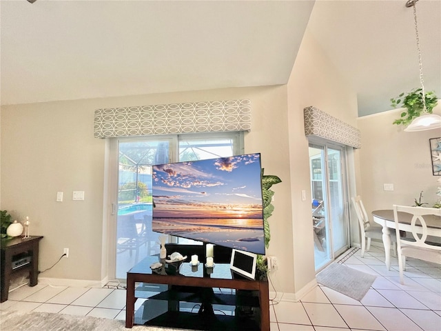 interior space with high vaulted ceiling, plenty of natural light, and light tile patterned floors