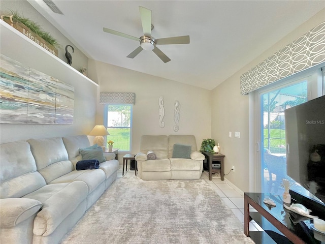 tiled living room featuring a wealth of natural light, vaulted ceiling, and ceiling fan