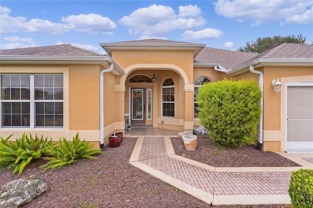 doorway to property with a garage