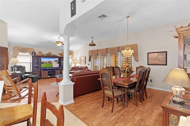 dining area with light hardwood / wood-style flooring, ceiling fan with notable chandelier, and decorative columns