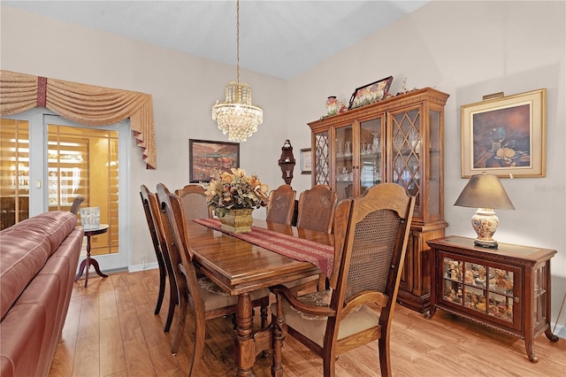 dining room featuring light hardwood / wood-style floors and an inviting chandelier