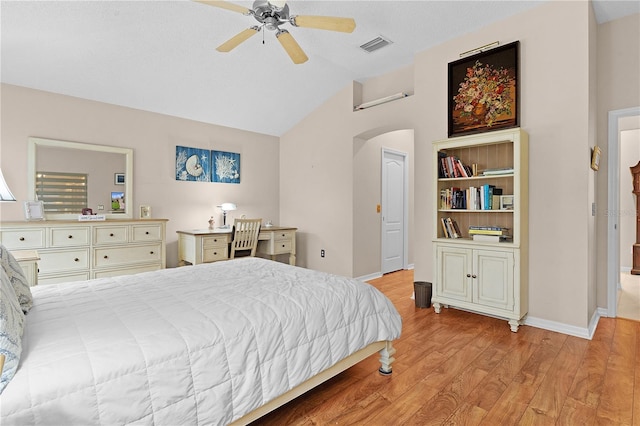 bedroom featuring light hardwood / wood-style flooring, a textured ceiling, vaulted ceiling, and ceiling fan