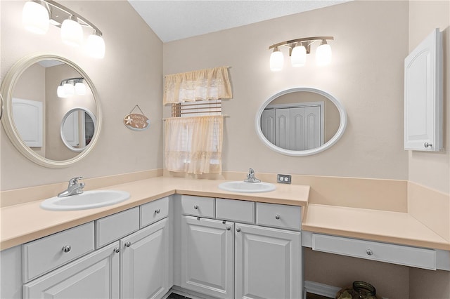 bathroom with vanity and a textured ceiling