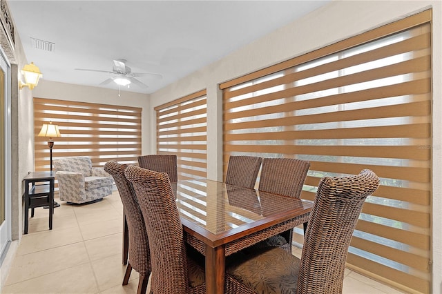 dining space with light tile patterned flooring and ceiling fan