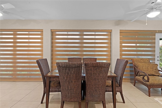 dining space featuring ceiling fan and light tile patterned floors