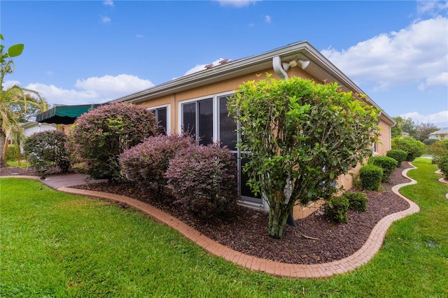 view of side of property with a yard