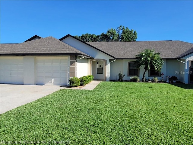 ranch-style home featuring a front lawn and a garage