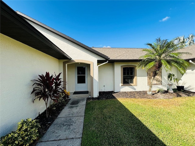 property entrance featuring a lawn