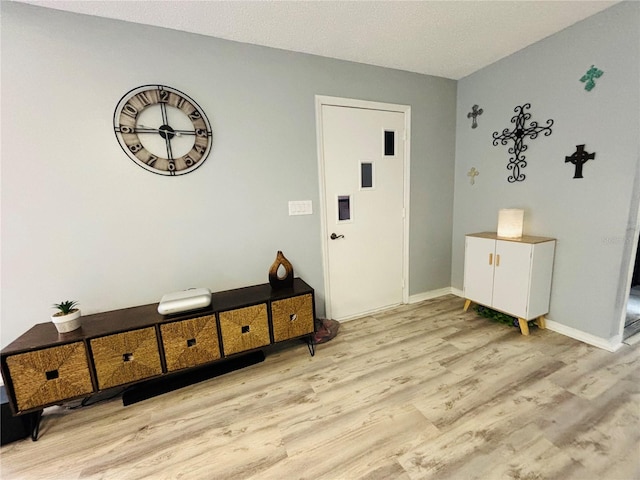 entrance foyer featuring a textured ceiling and light wood-type flooring