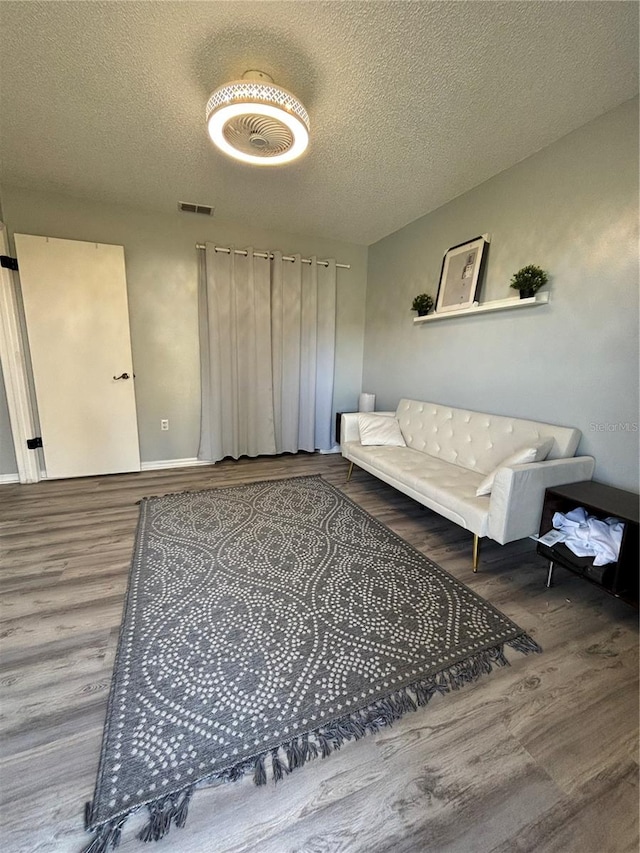 sitting room featuring hardwood / wood-style floors and a textured ceiling