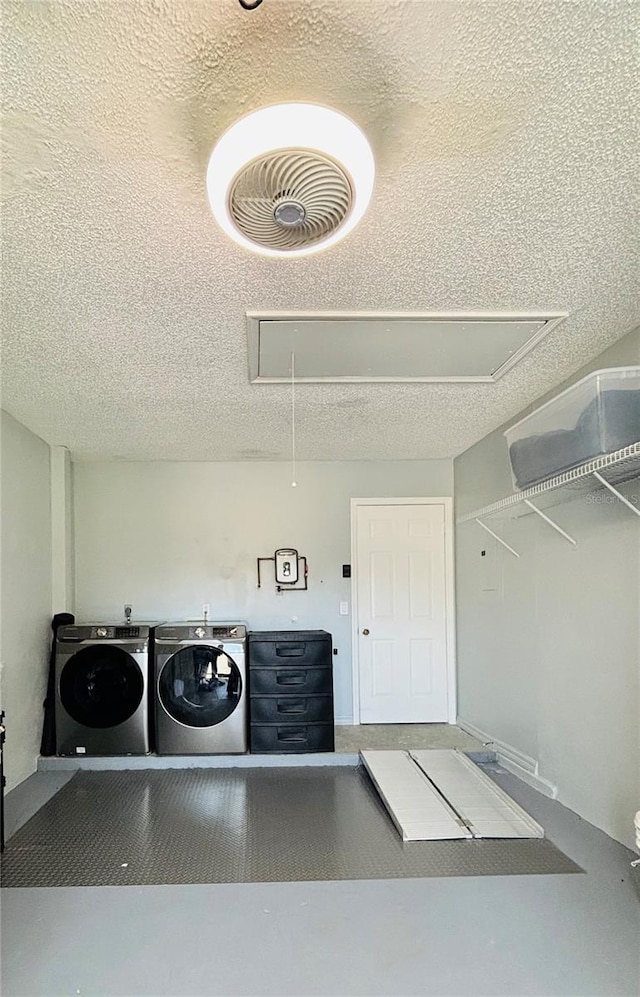 washroom with independent washer and dryer and a textured ceiling