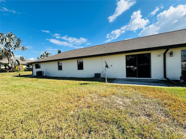 back of property with a patio, cooling unit, and a lawn