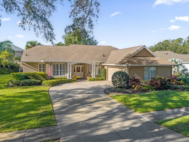 ranch-style house with a garage and a front lawn