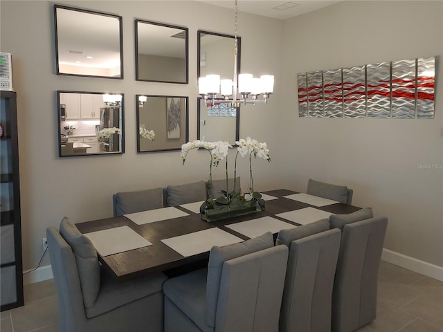 dining area featuring a notable chandelier and tile patterned flooring