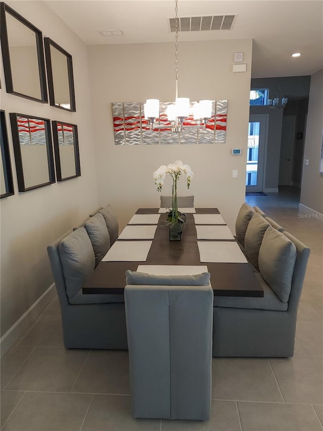 tiled dining area with a notable chandelier