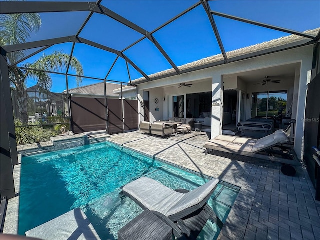 view of swimming pool with an outdoor hangout area, ceiling fan, a hot tub, a lanai, and a patio area