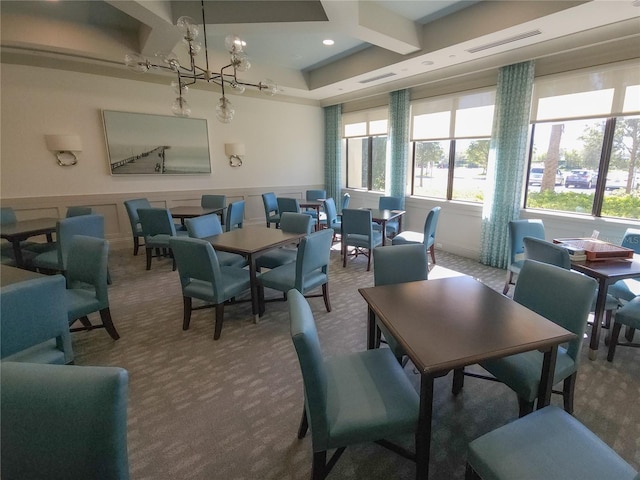 carpeted dining room featuring an inviting chandelier