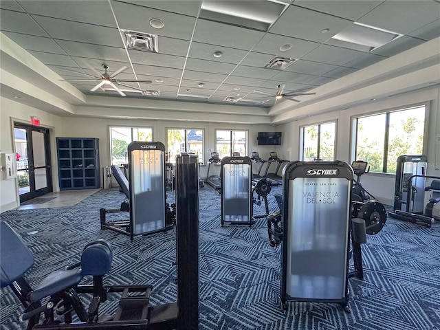 gym featuring french doors, a paneled ceiling, carpet floors, and ceiling fan