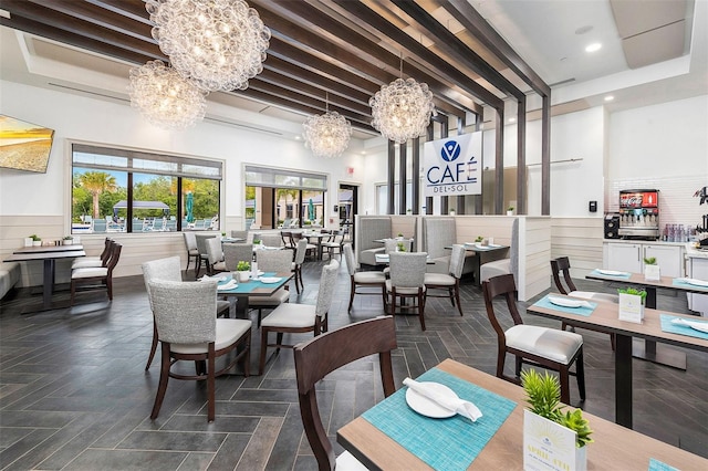 dining area with a tray ceiling and a high ceiling