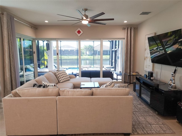 tiled living room with ceiling fan