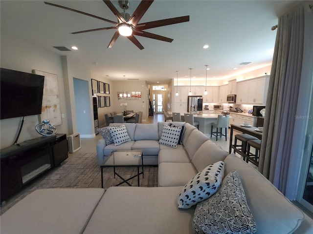 living room with carpet and ceiling fan