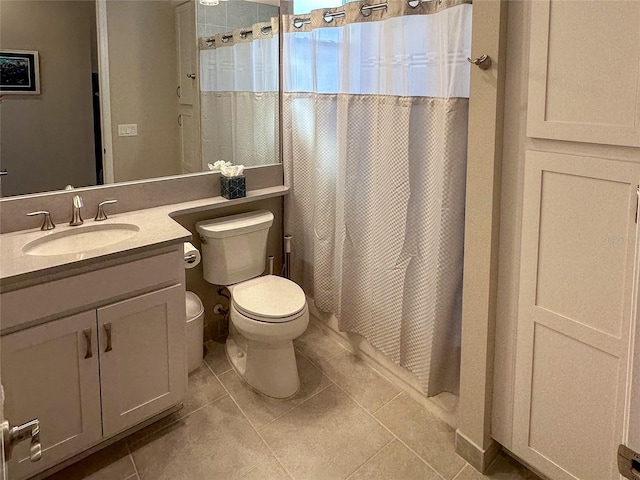 bathroom featuring vanity, toilet, tile patterned floors, and a shower with curtain