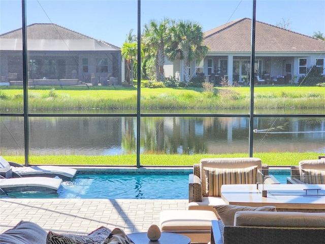 view of pool with an outdoor hot tub, a yard, a water view, and glass enclosure