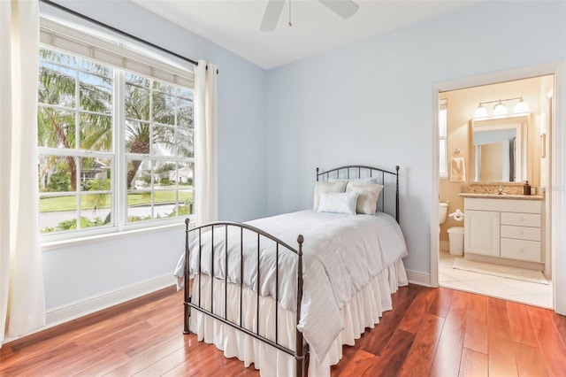 bedroom featuring ensuite bathroom, ceiling fan, and hardwood / wood-style flooring