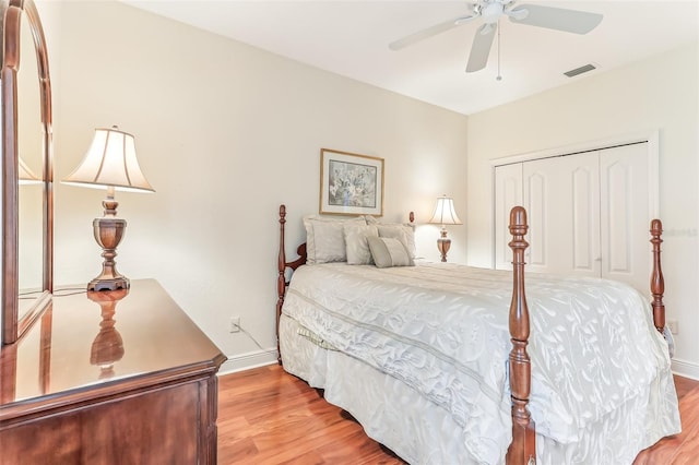 bedroom with a closet, visible vents, light wood-style flooring, and baseboards