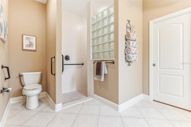 bathroom with toilet, baseboards, walk in shower, and tile patterned floors