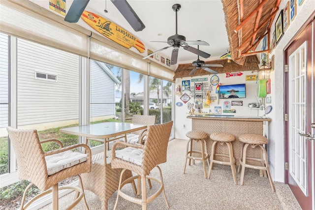 sunroom featuring ceiling fan