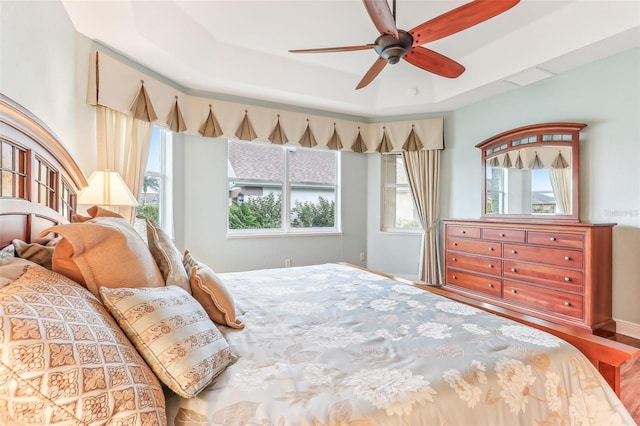 bedroom featuring ceiling fan and a raised ceiling