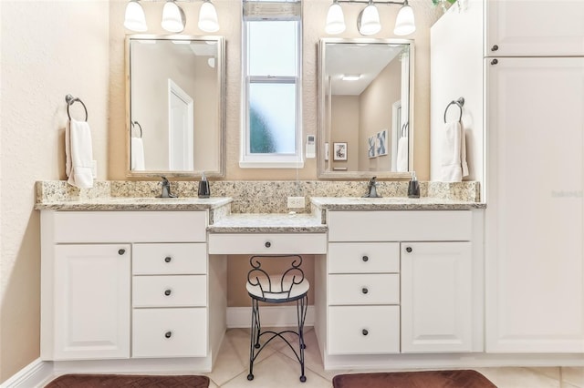 bathroom with tile patterned floors and vanity