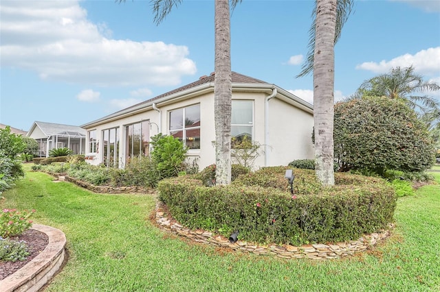 view of property exterior with a lawn and stucco siding