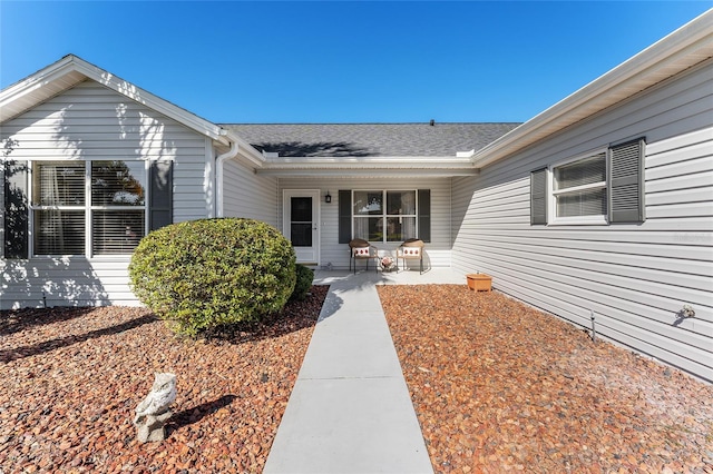 1312 Landeros Ln, The Villages, FL 32159 - view of exterior entry with a shingled roof