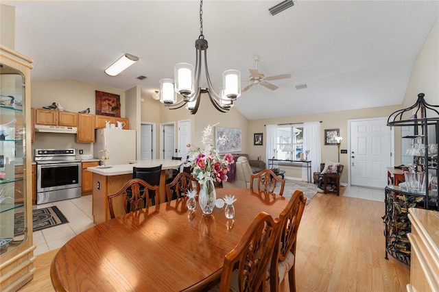 dining area featuring vaulted ceiling, light hardwood / wood-style flooring, a textured ceiling, and ceiling fan with notable chandelier