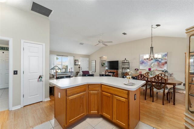 1312 Landeros Ln, The Villages, FL 32159 - kitchen featuring visible vents, vaulted ceiling, light countertops, ceiling fan with notable chandelier, and open floor plan
