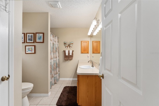 bathroom with toilet, tile patterned flooring, vanity, a textured ceiling, and walk in shower