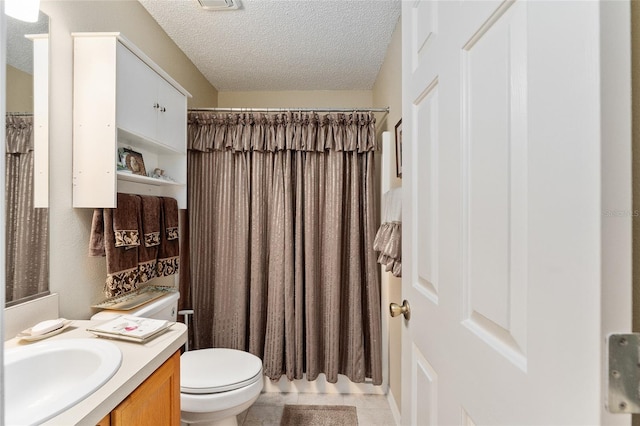 bathroom featuring vanity, a textured ceiling, toilet, and tile patterned floors