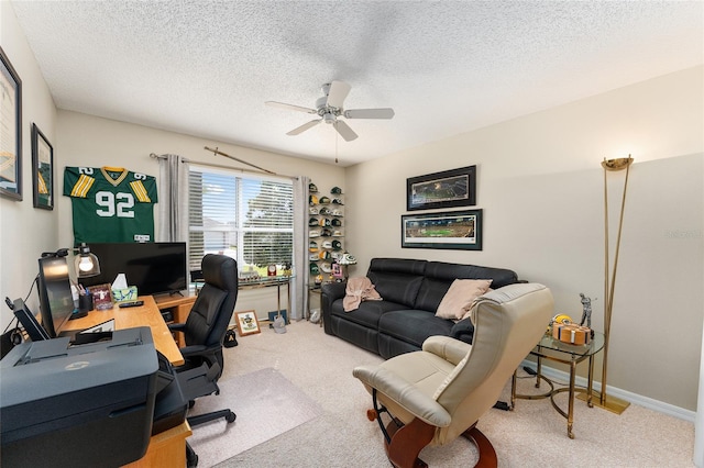 carpeted office featuring a textured ceiling and ceiling fan