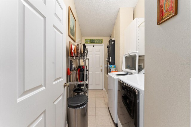 1312 Landeros Ln, The Villages, FL 32159 - washroom with light tile patterned floors, cabinet space, a textured ceiling, and washing machine and clothes dryer