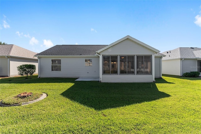 1312 Landeros Ln, The Villages, FL 32159 - rear view of property featuring a lawn, a sunroom, and a patio area
