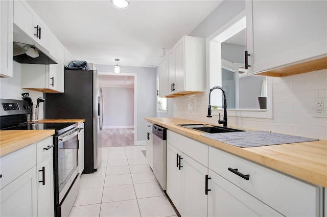 kitchen with backsplash, appliances with stainless steel finishes, sink, and white cabinets