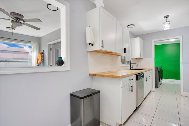 kitchen featuring butcher block countertops, sink, white cabinetry, and dishwasher