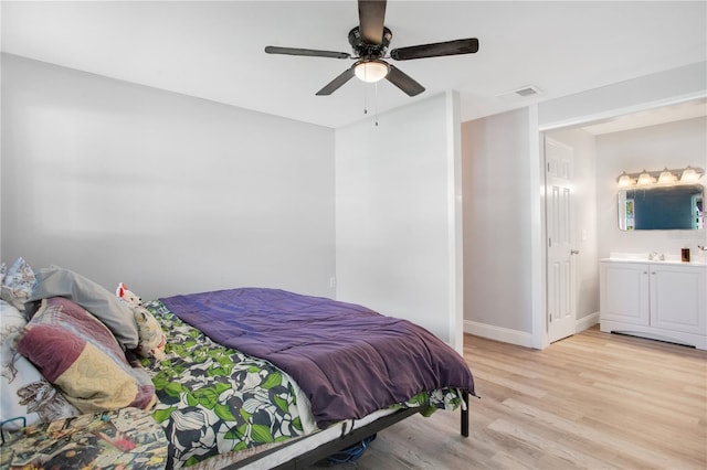 bedroom with sink, ceiling fan, ensuite bathroom, and light hardwood / wood-style floors