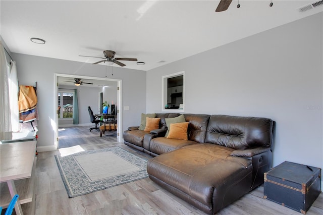 living room with hardwood / wood-style floors and ceiling fan