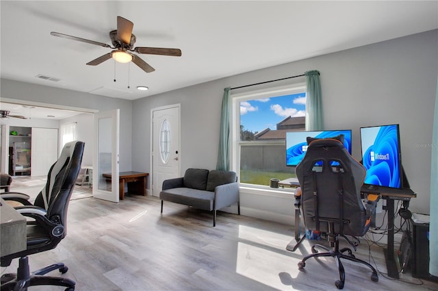 home office featuring light hardwood / wood-style floors and ceiling fan