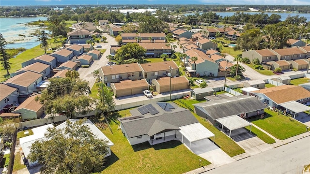 birds eye view of property featuring a water view and a residential view